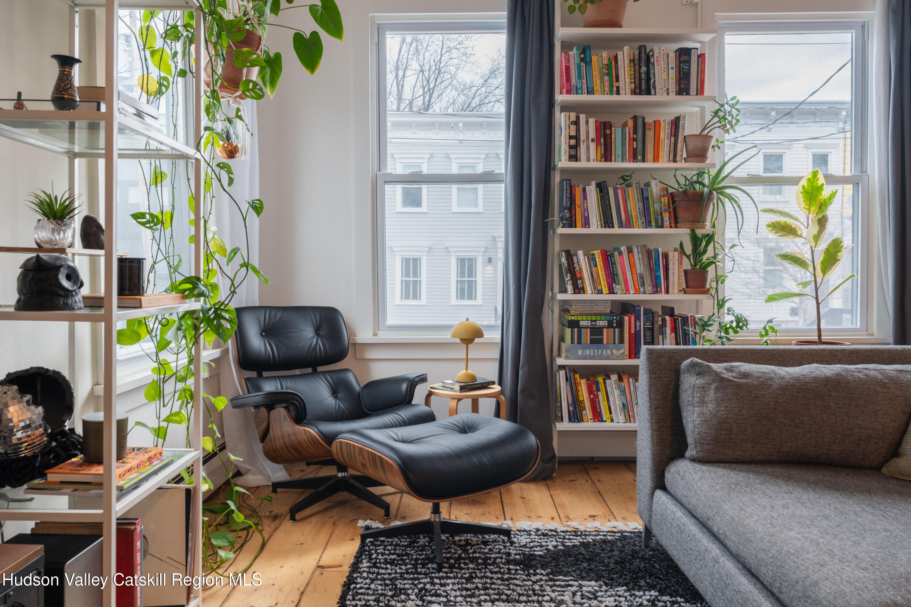 517 State Street Hudson, NY 12534 - Photo 13 of 36 a living room with furniture and a book shelf