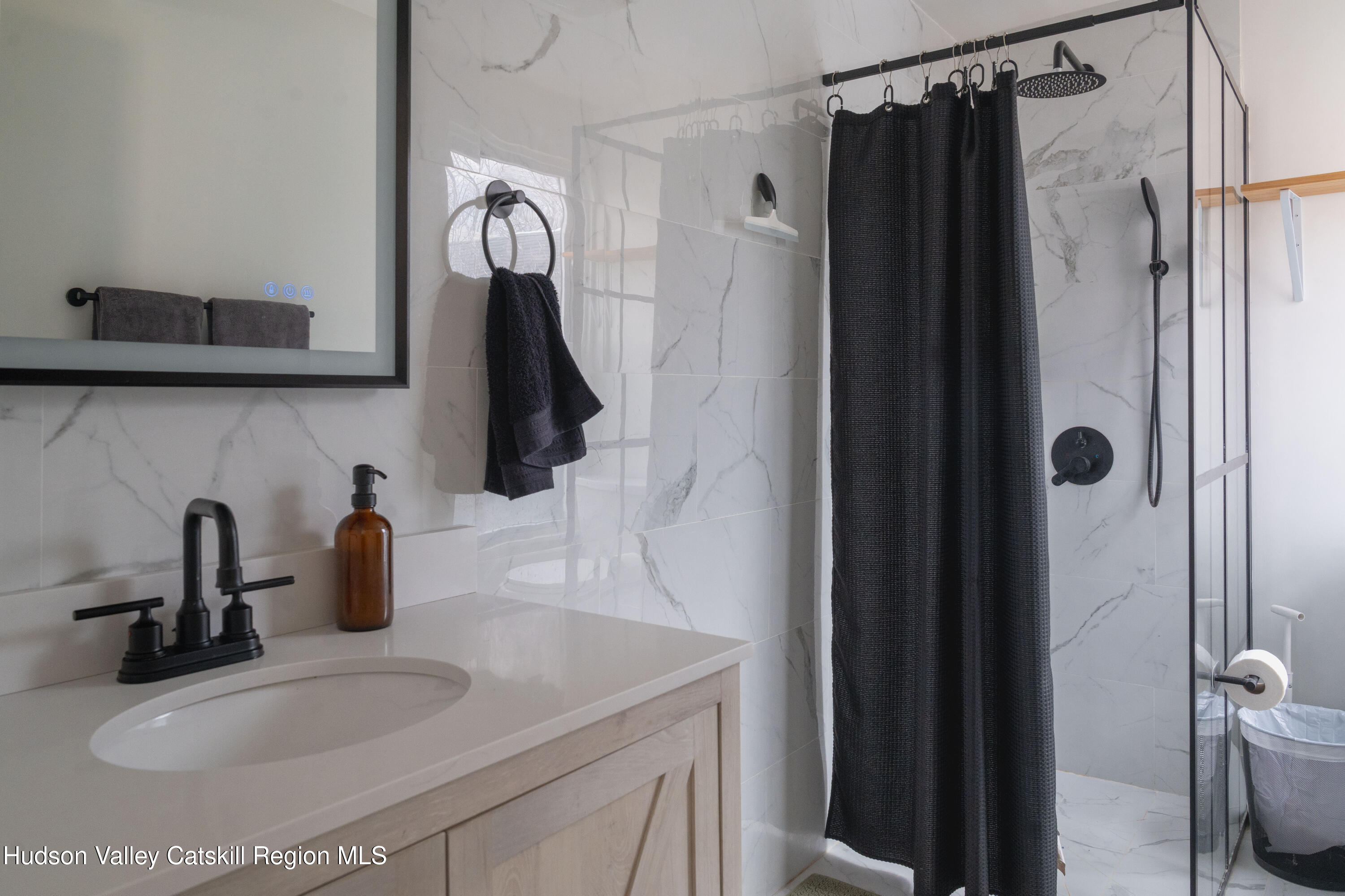 517 State Street Hudson, NY 12534 - Photo 25 of 36 a bathroom with a sink and a mirror
