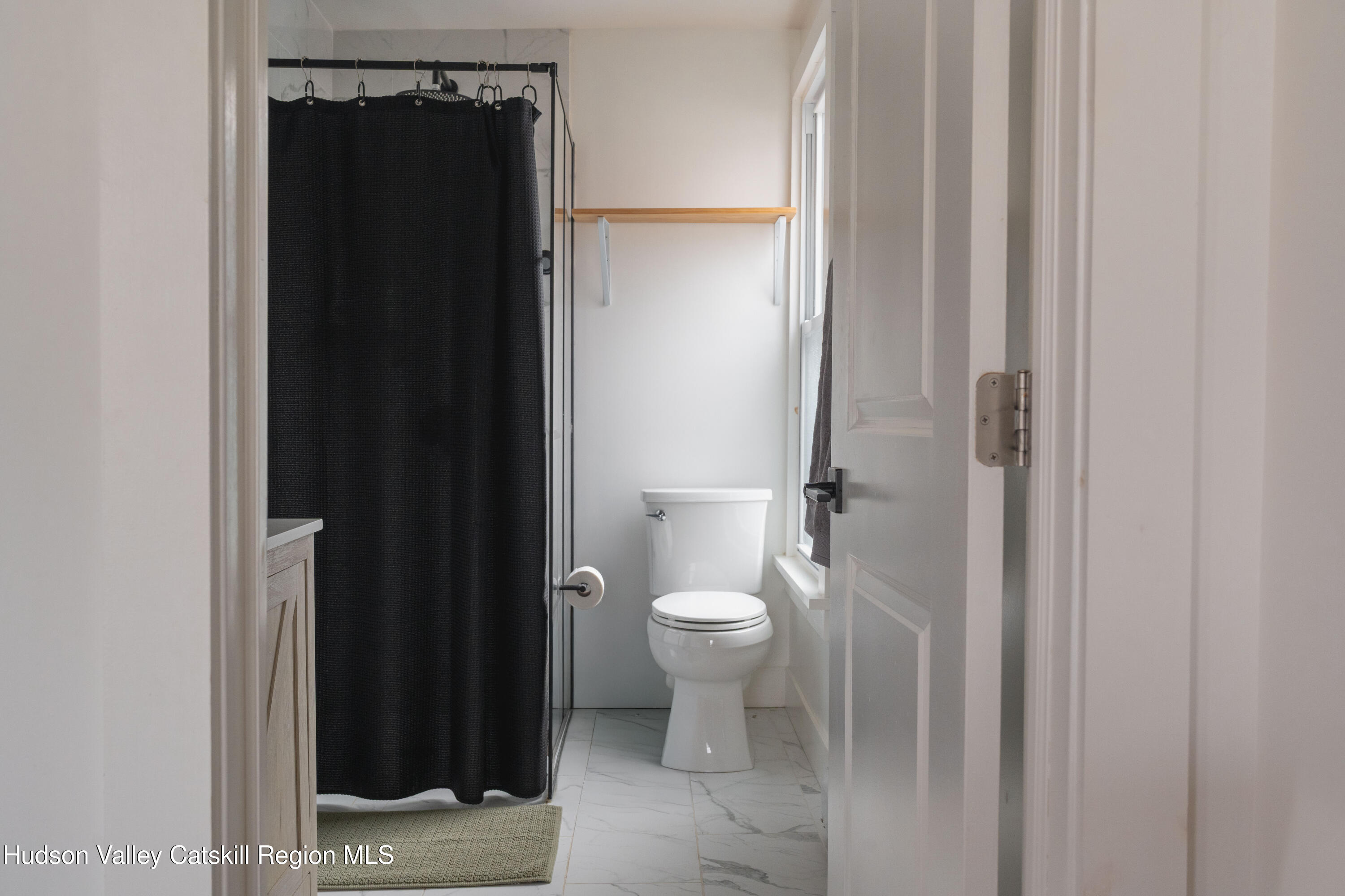 517 State Street Hudson, NY 12534 - Photo 26 of 36 a bathroom with a toilet and a shower