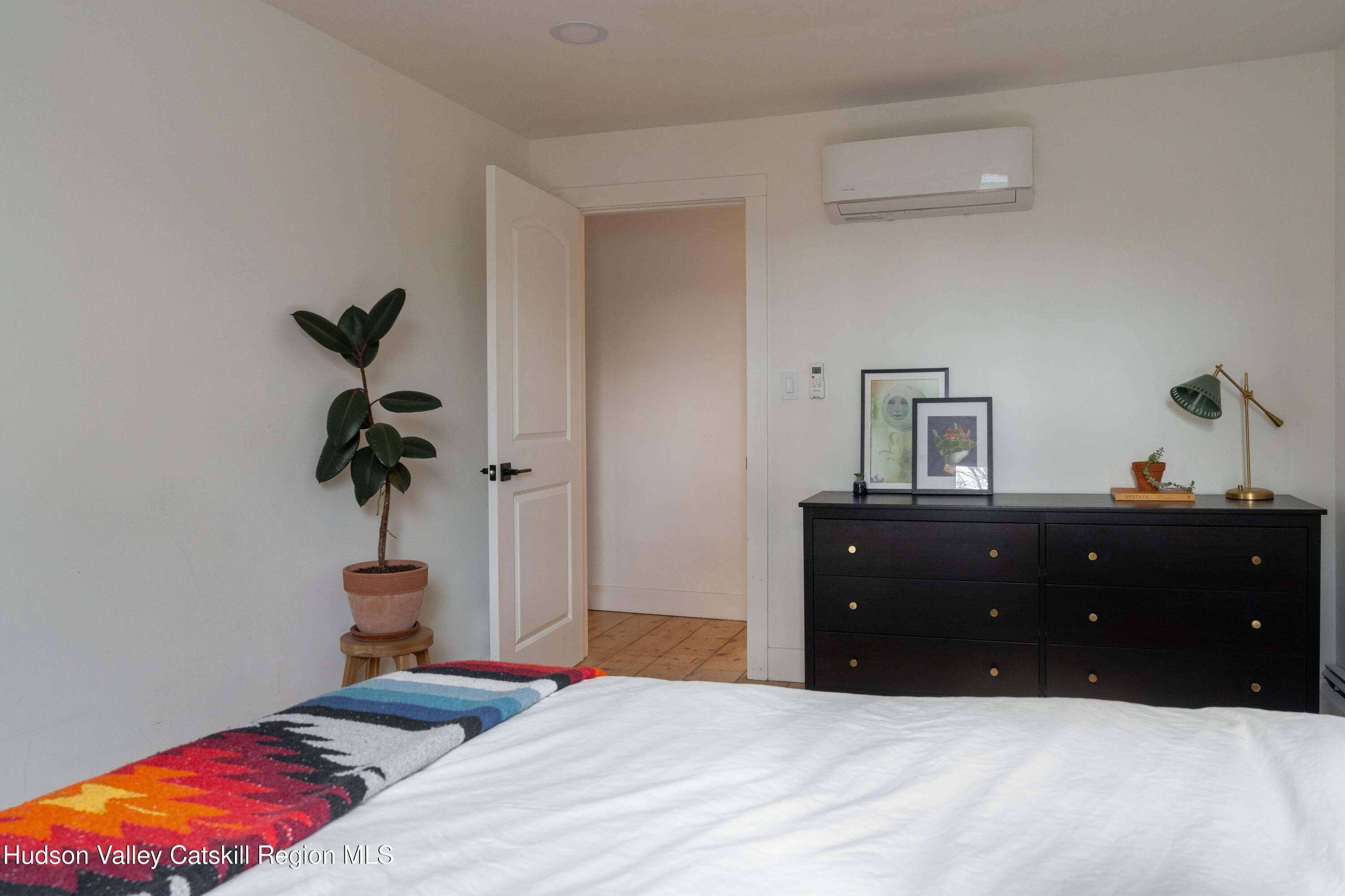 517 State Street Hudson, NY 12534 - Photo 28 of 36 a bedroom with a bed and a potted plant