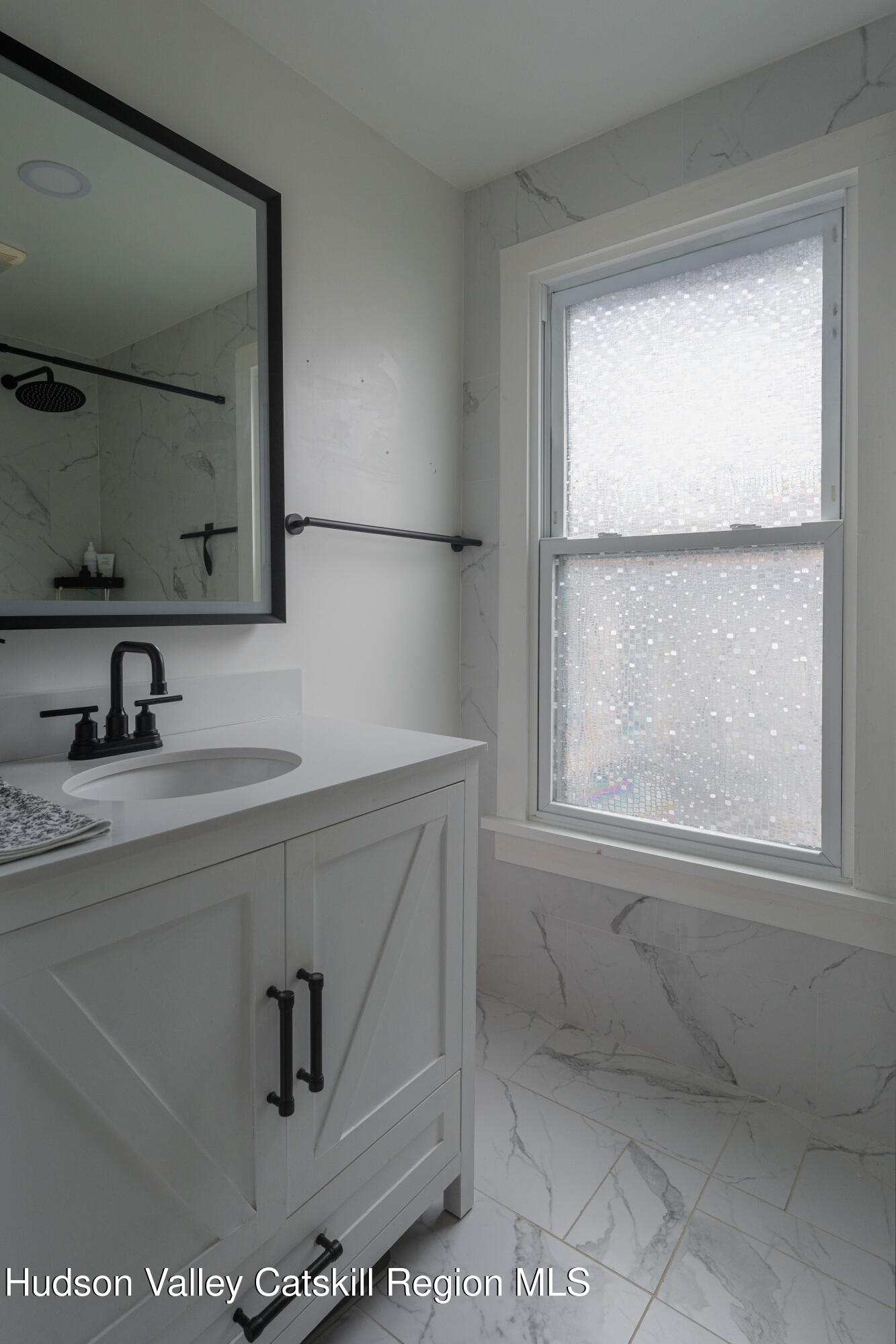 517 State Street Hudson, NY 12534 - Photo 30 of 36 a bathroom with a sink a mirror and a window
