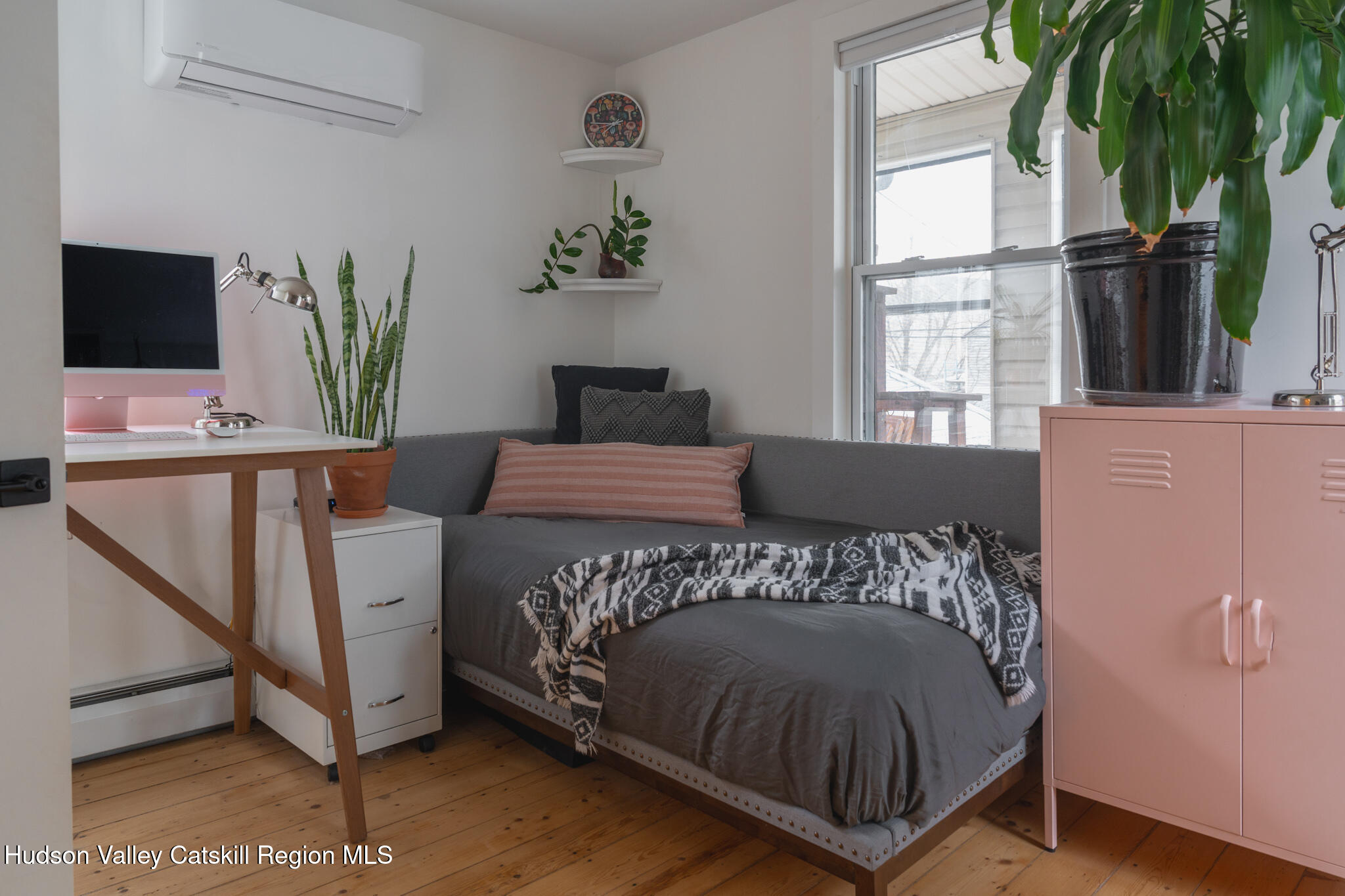 517 State Street Hudson, NY 12534 - Photo 31 of 36 a bedroom with a bed window and potted plant on the wall
