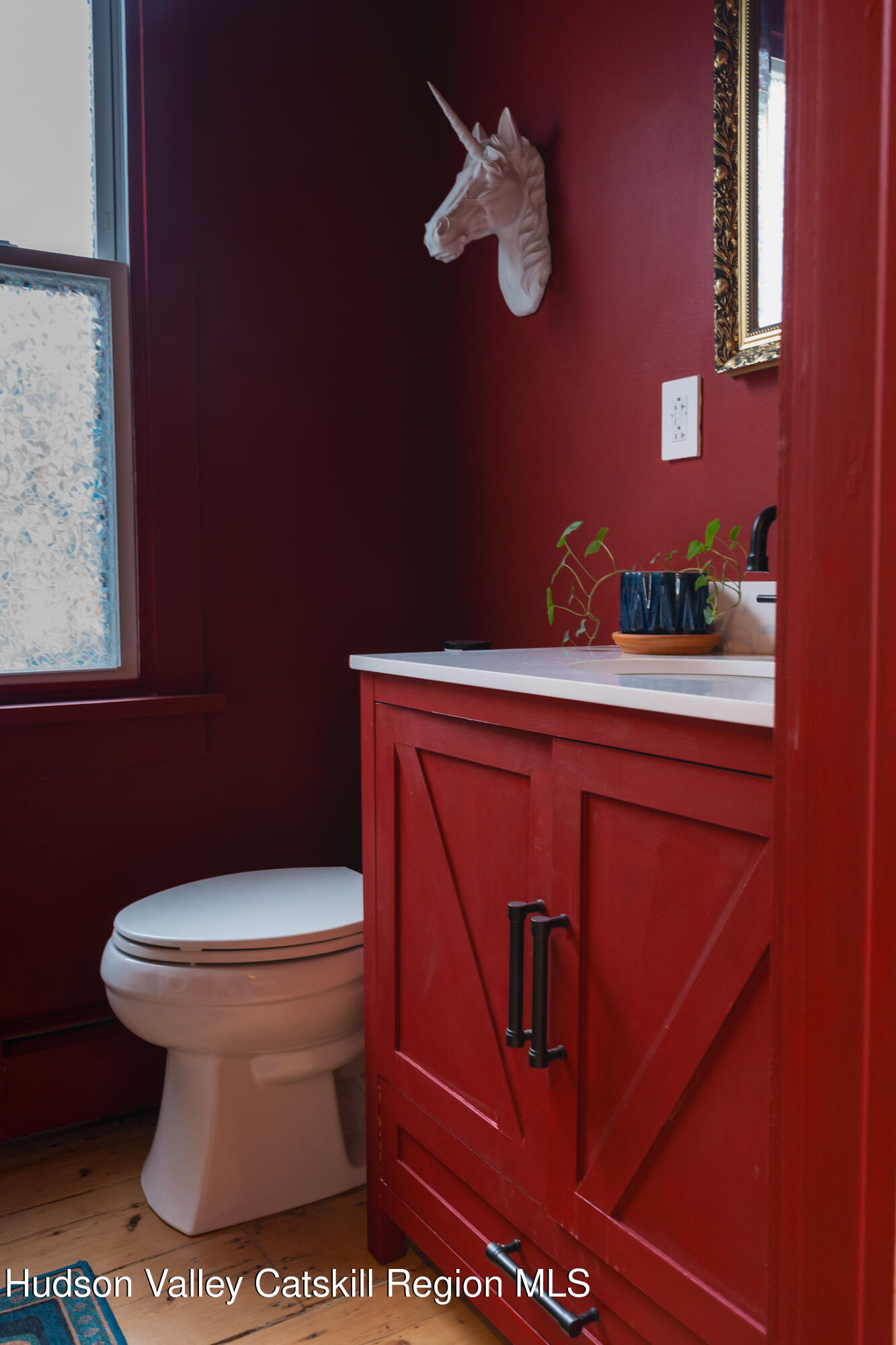 517 State Street Hudson, NY 12534 - Photo 6 of 36 a bathroom with a sink a toilet and mirror