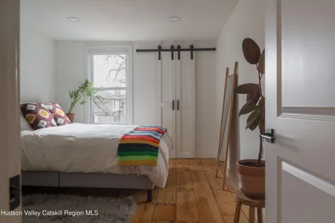 a bedroom with a bed and a window