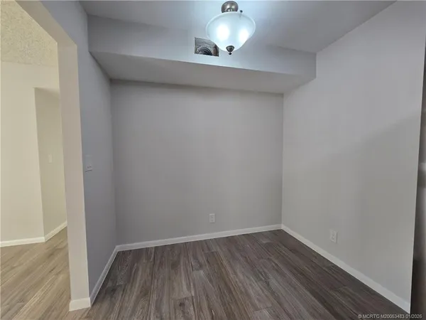 a view of an empty room and wooden floor