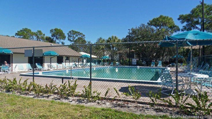 2114 Southwest Silver Pine Way, Unit 121F1 Palm City, FL 34990 - Photo 12 of 13 a view of house with a yard and sitting area