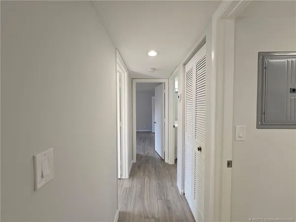 a view of a hallway with wooden floor