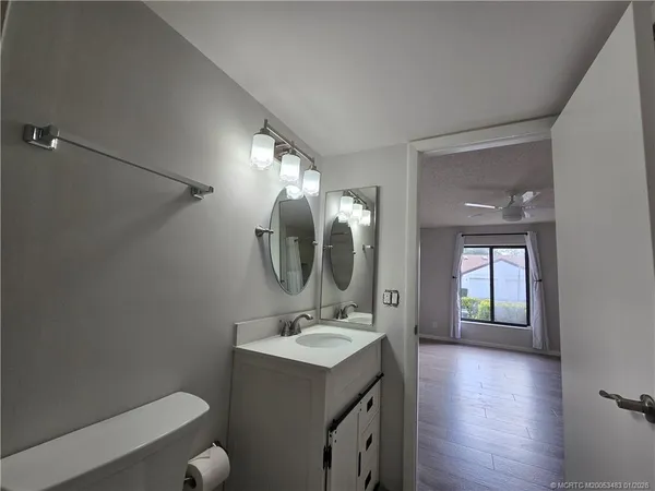a bathroom with a sink vanity granite and a mirror