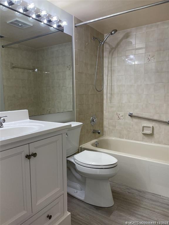 2114 Southwest Silver Pine Way, Unit 121F1 Palm City, FL 34990 - Photo 6 of 13 a bathroom with a sink toilet and shower