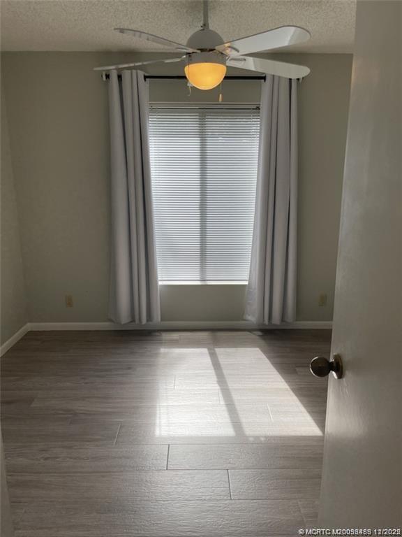 2114 Southwest Silver Pine Way, Unit 121F1 Palm City, FL 34990 - Photo 8 of 13 a view of a closet with wooden floor