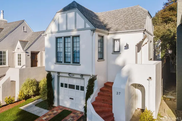 a front view of a house with many windows