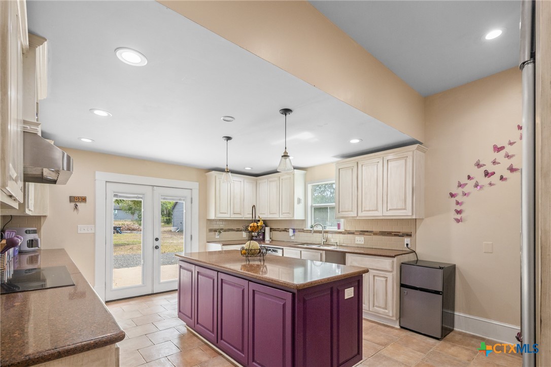 612 Wilbern Street Runge, TX 78151 - Photo 13 of 33 a kitchen with stainless steel appliances granite countertop a sink stove and refrigerator