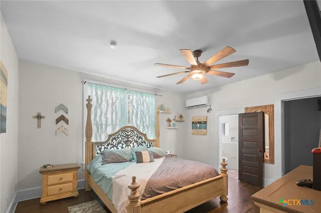 a bedroom with a bed and a chandelier
