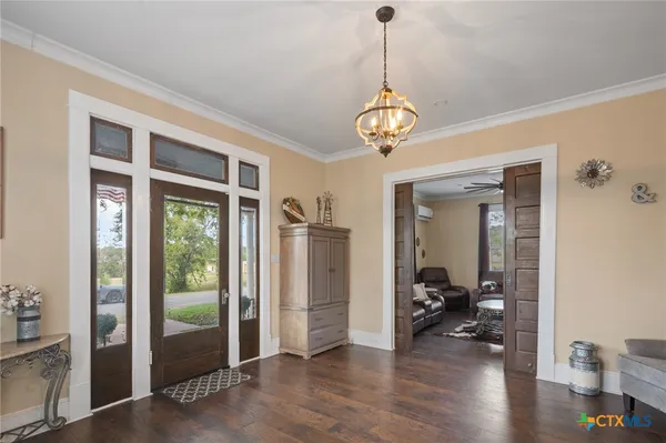 a view of a livingroom with wooden floor and workspace