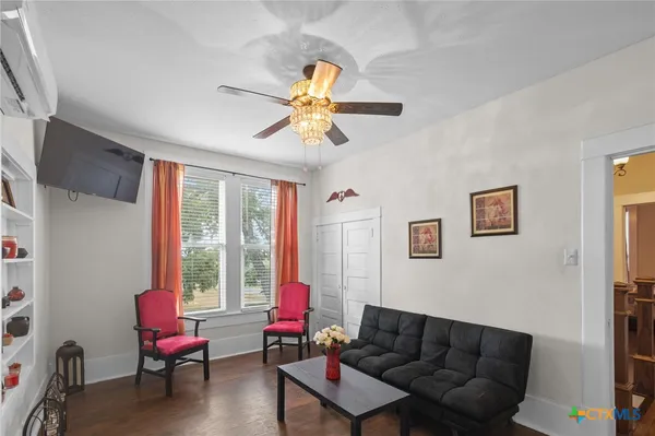 a living room with furniture a couch and a window