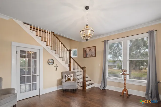 a view of a livingroom with wooden floor and stairs