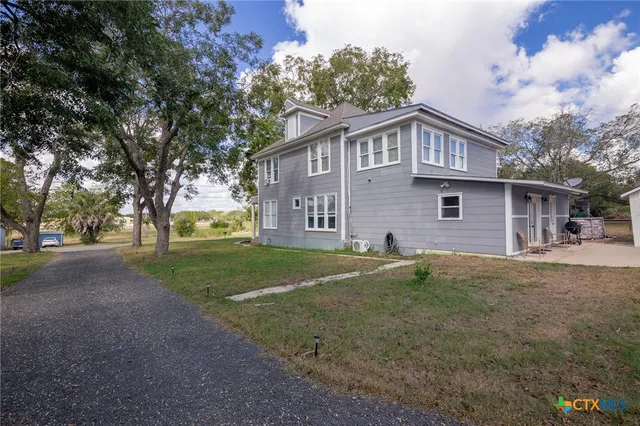 a large tree in front of a house