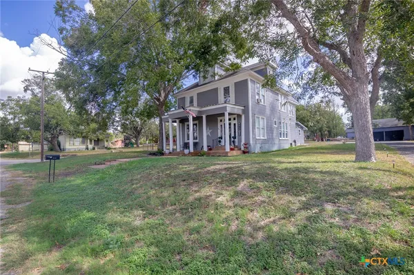 a view of house with outdoor space and garden