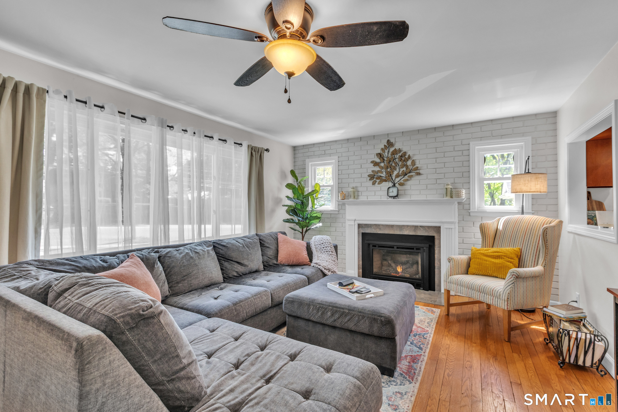 597 Wolcott Hill Road Wethersfield, CT 06109 - Photo 11 of 35 a living room with furniture fireplace and a large window