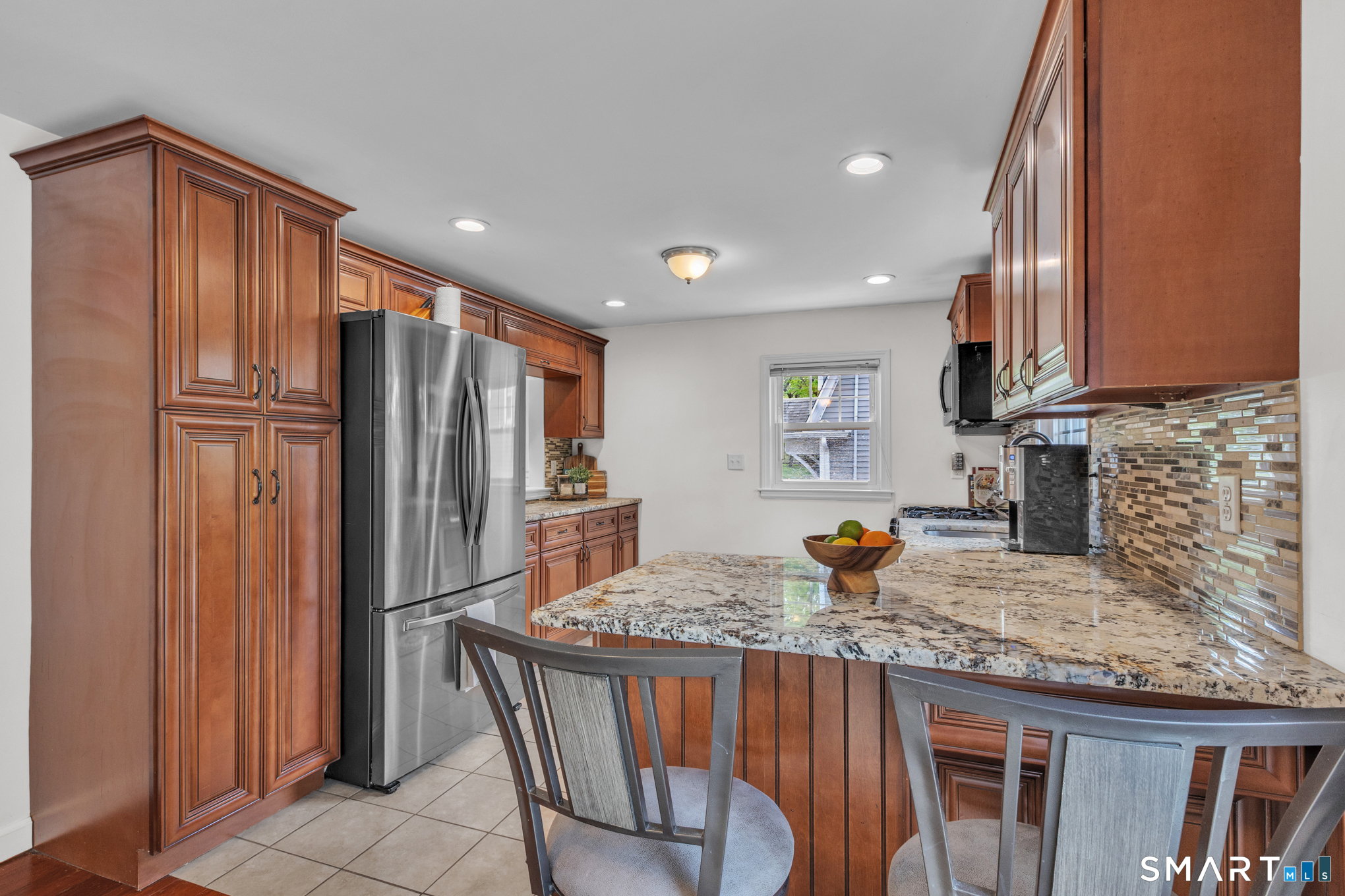 597 Wolcott Hill Road Wethersfield, CT 06109 - Photo 19 of 35 a kitchen with stainless steel appliances granite countertop a refrigerator and a sink
