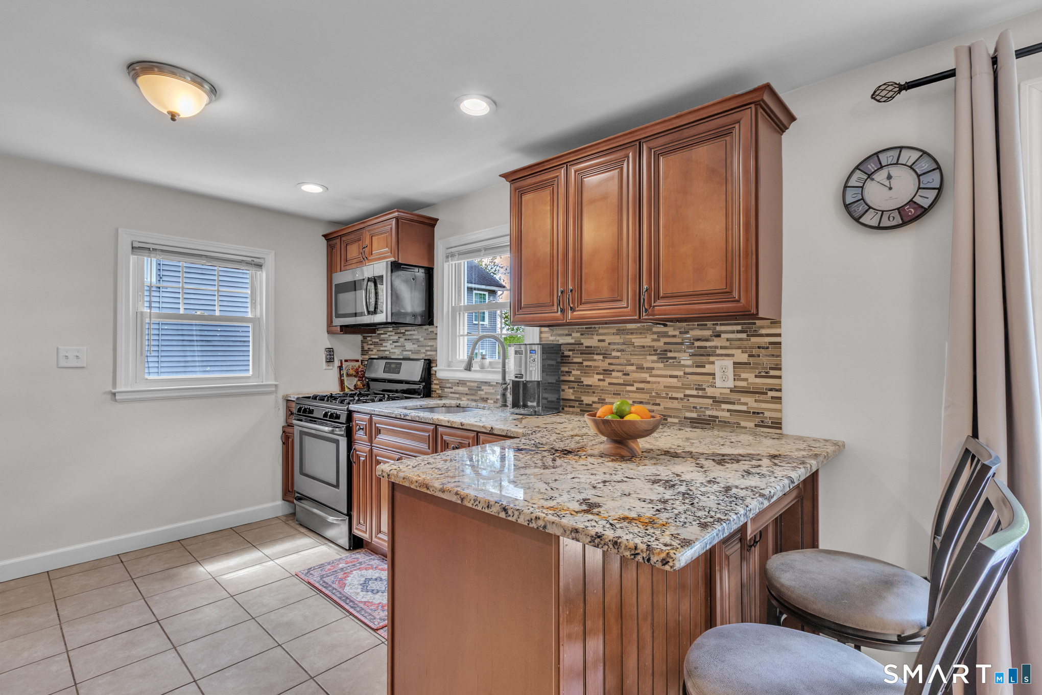 597 Wolcott Hill Road Wethersfield, CT 06109 - Photo 20 of 35 a kitchen with a stove a sink cabinetry a stove and a refrigerator