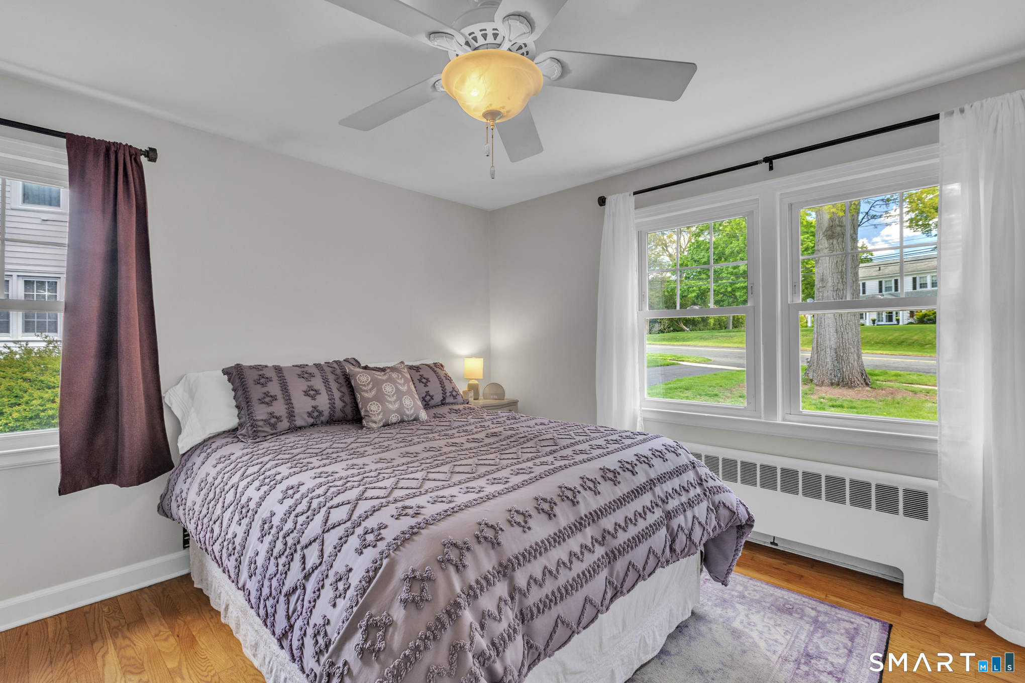 597 Wolcott Hill Road Wethersfield, CT 06109 - Photo 23 of 35 a bedroom with a bed and a chandelier