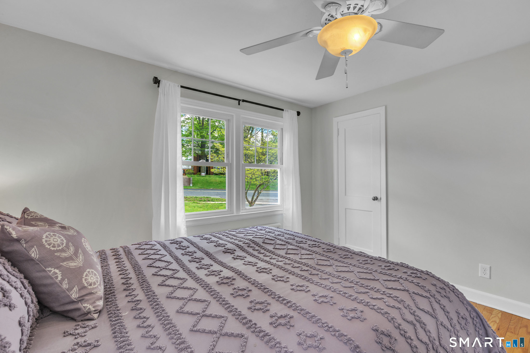 597 Wolcott Hill Road Wethersfield, CT 06109 - Photo 24 of 35 a bedroom with a bed and a window
