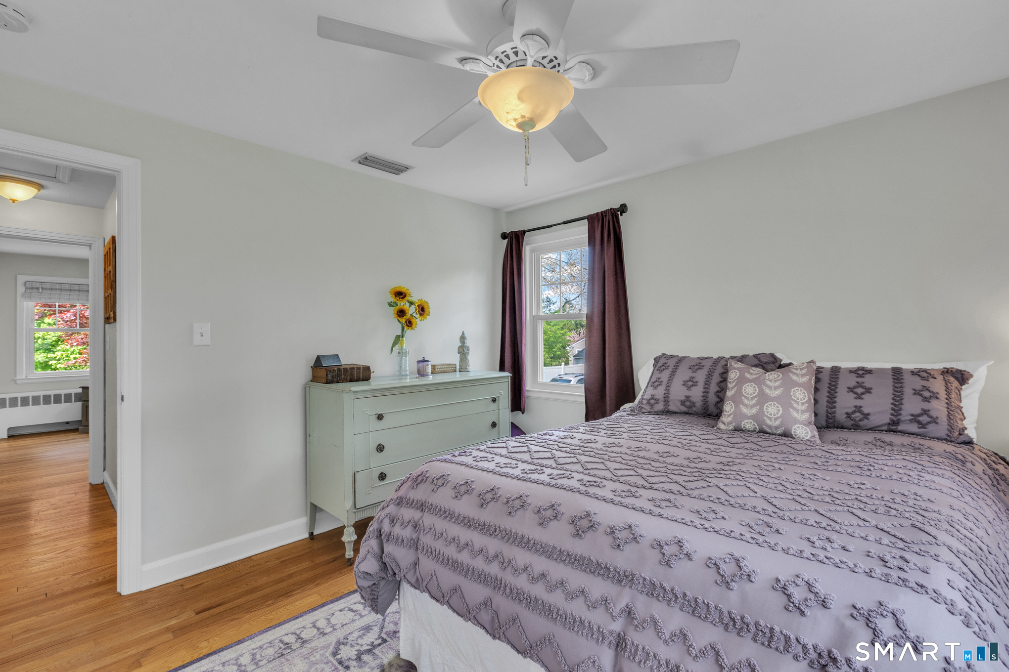 597 Wolcott Hill Road Wethersfield, CT 06109 - Photo 25 of 35 a bedroom with a bed and a chandelier