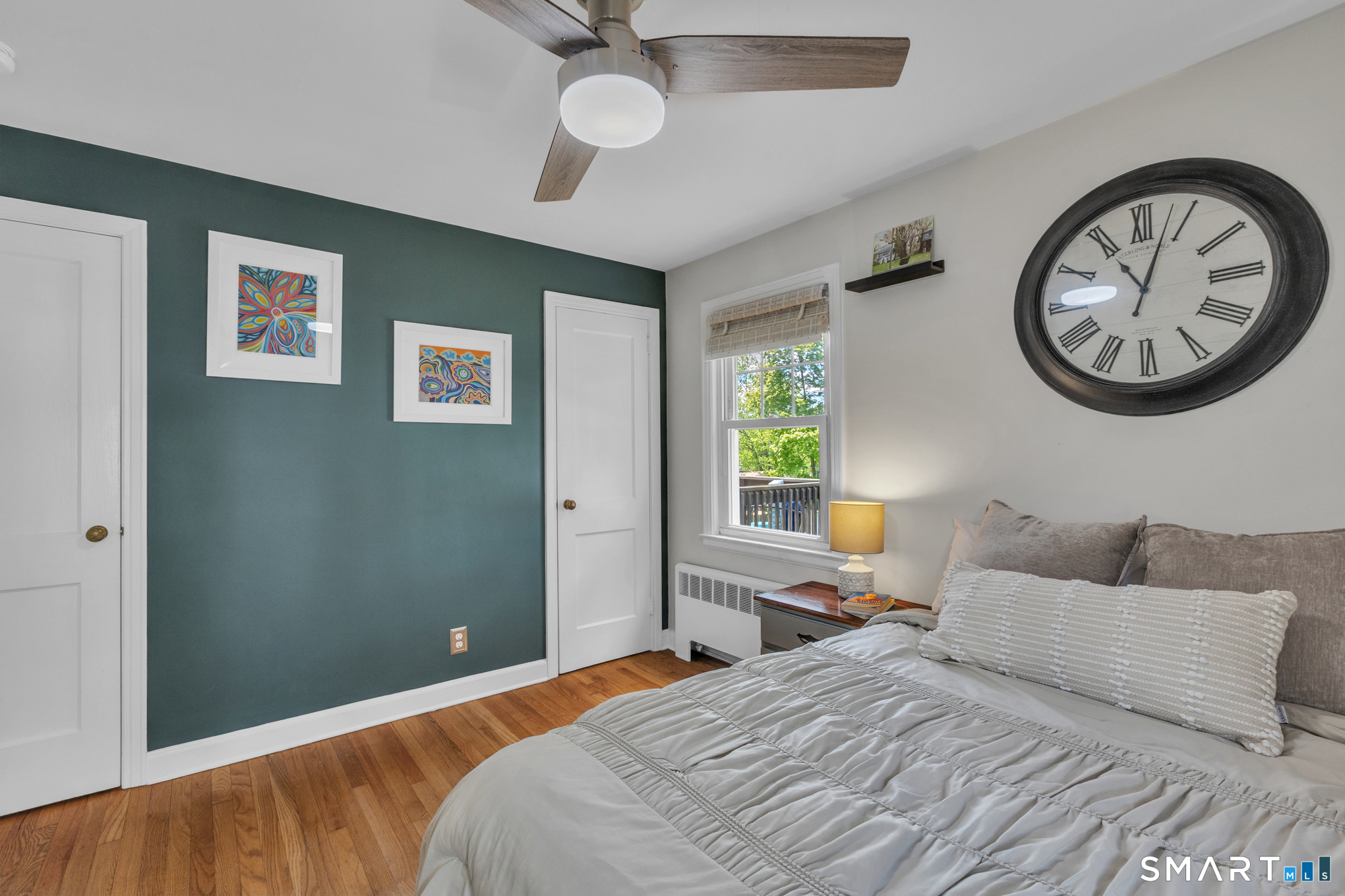 597 Wolcott Hill Road Wethersfield, CT 06109 - Photo 28 of 35 a bedroom with a bed and a large mirror