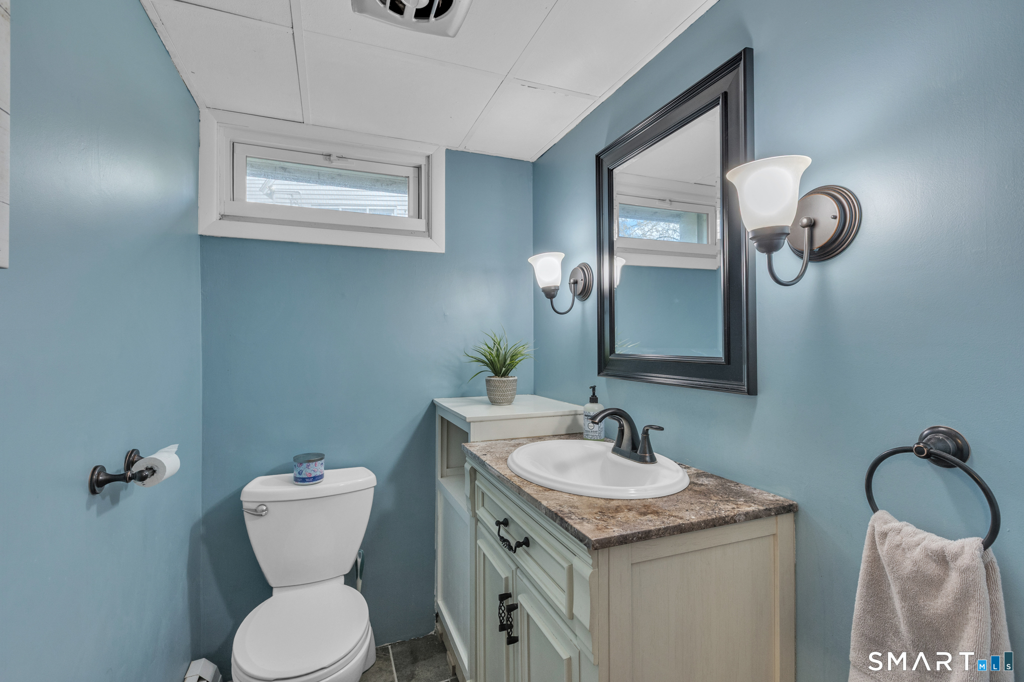 597 Wolcott Hill Road Wethersfield, CT 06109 - Photo 35 of 35 a bathroom with a granite countertop toilet sink and mirror