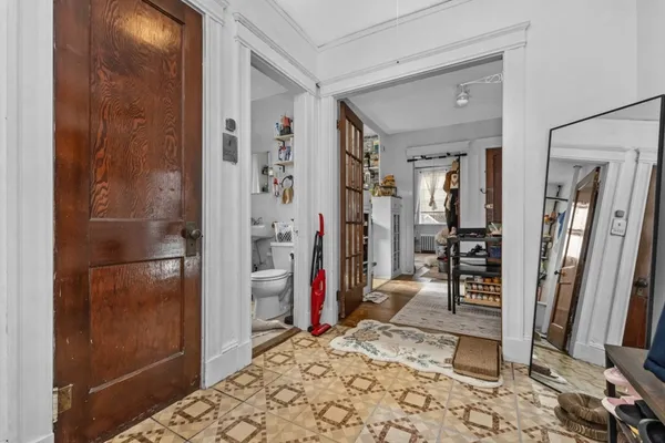 a view of a hallway with a furniture and a living room