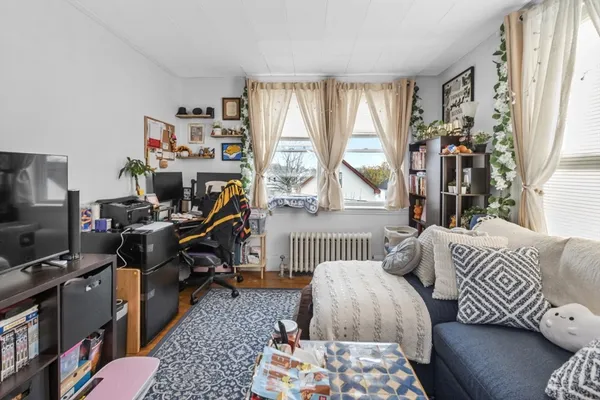 a bedroom with furniture and a window