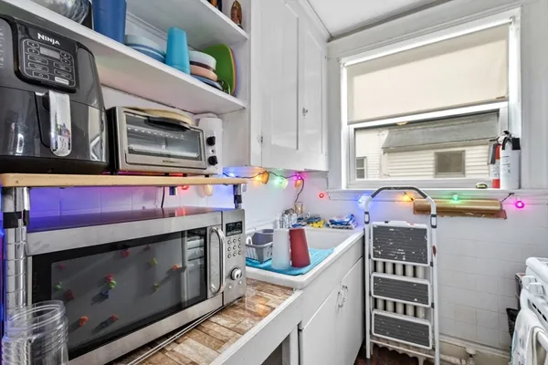 a kitchen with stainless steel appliances a stove and a microwave