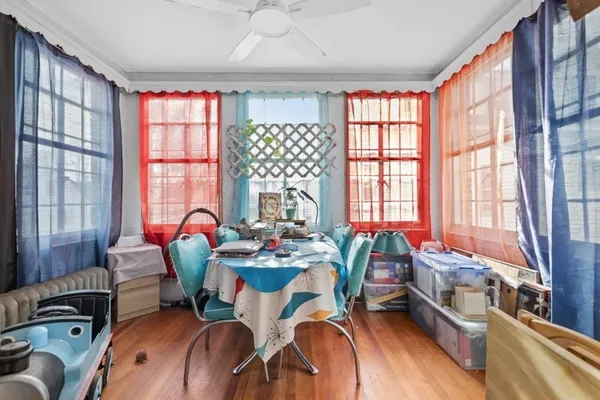 a view of a dining room with furniture a chandelier and wooden floor