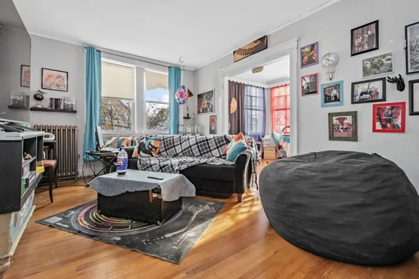 a living room with furniture and a floor to ceiling window