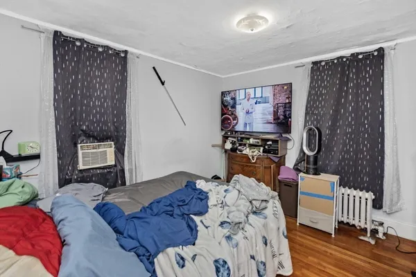 a bedroom with furniture and a window