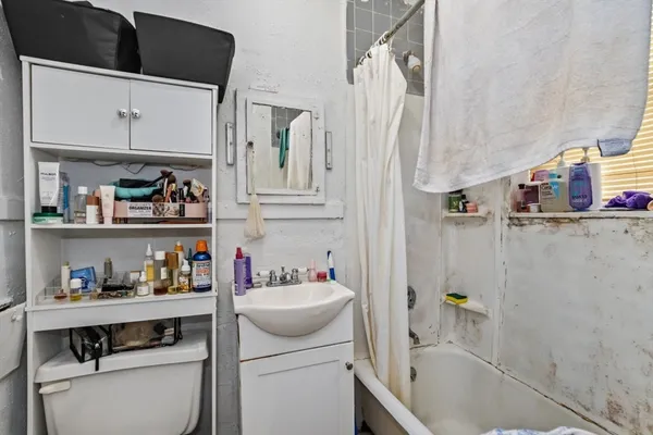 a bathroom with a sink toilet and shower