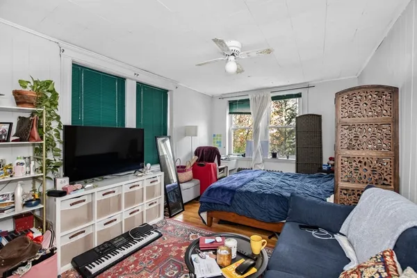 a bedroom with furniture and a flat screen tv