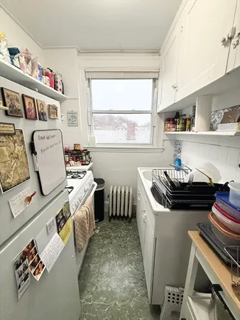 a kitchen with a stove a sink and a refrigerator