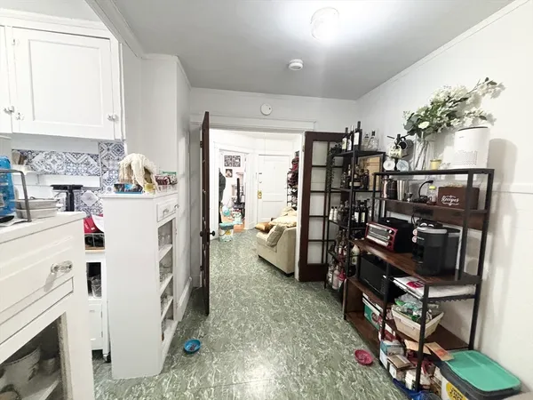 a view of a kitchen with fridge and workspace