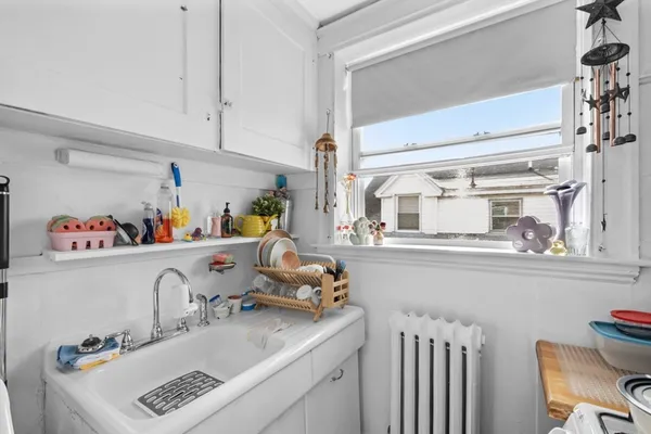 a kitchen with a sink cabinets and a window