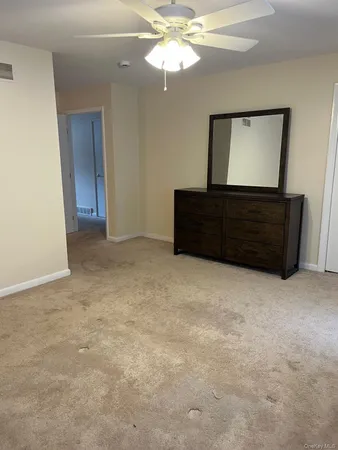 a view of room with a ceiling fan