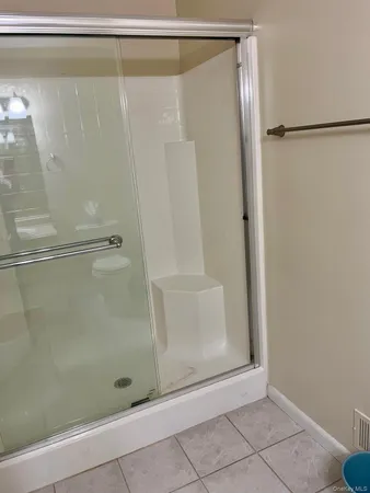 a bathroom with a glass shower door