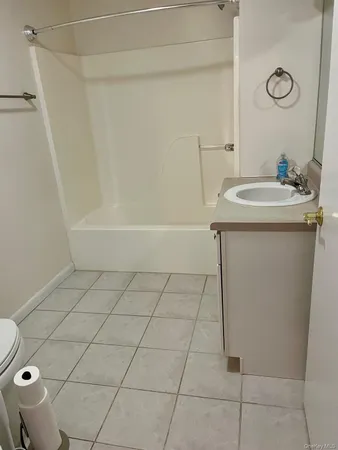a bathroom with a granite countertop sink a toilet and a mirror