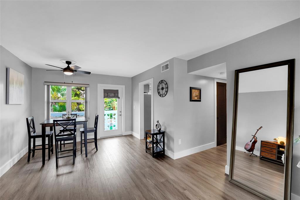 2161 Northeast 42nd Court, Unit 215 Lighthouse Point, FL 33064 - Photo 11 of 50 a view of a livingroom with furniture window and wooden floor