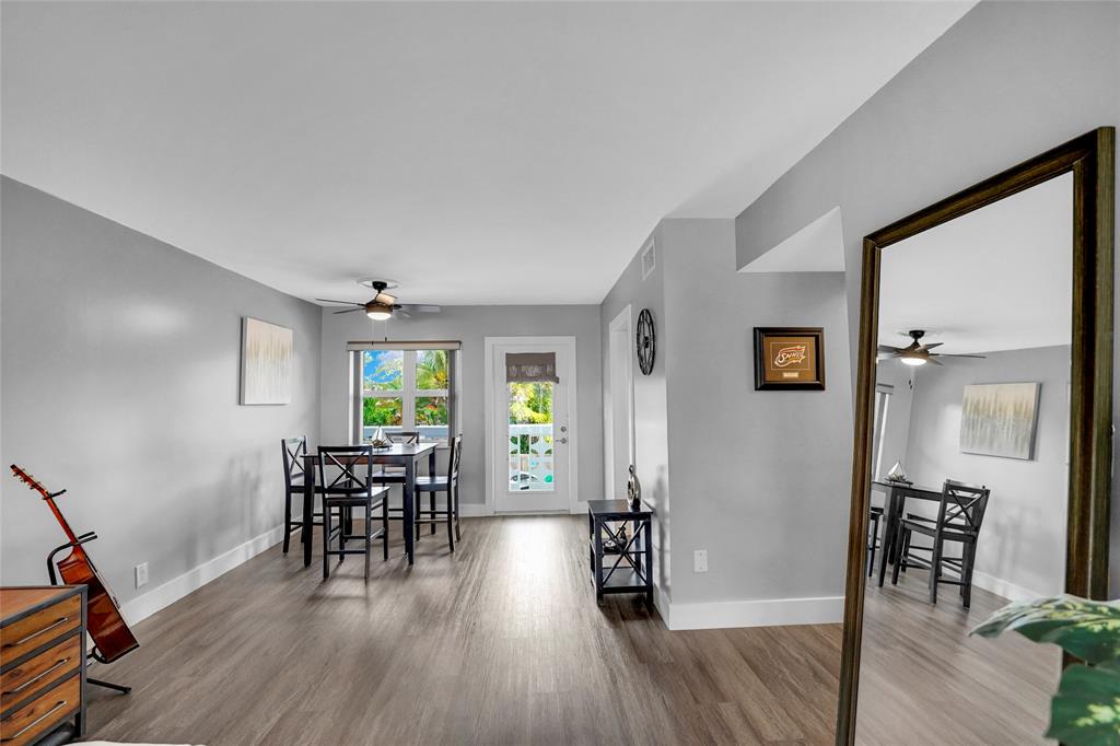 2161 Northeast 42nd Court, Unit 215 Lighthouse Point, FL 33064 - Photo 12 of 50 a view of a livingroom with furniture and hardwood floor
