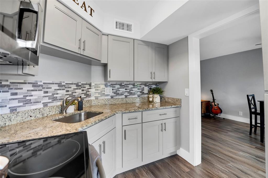 2161 Northeast 42nd Court, Unit 215 Lighthouse Point, FL 33064 - Photo 17 of 50 a kitchen with sink a stove and cabinets