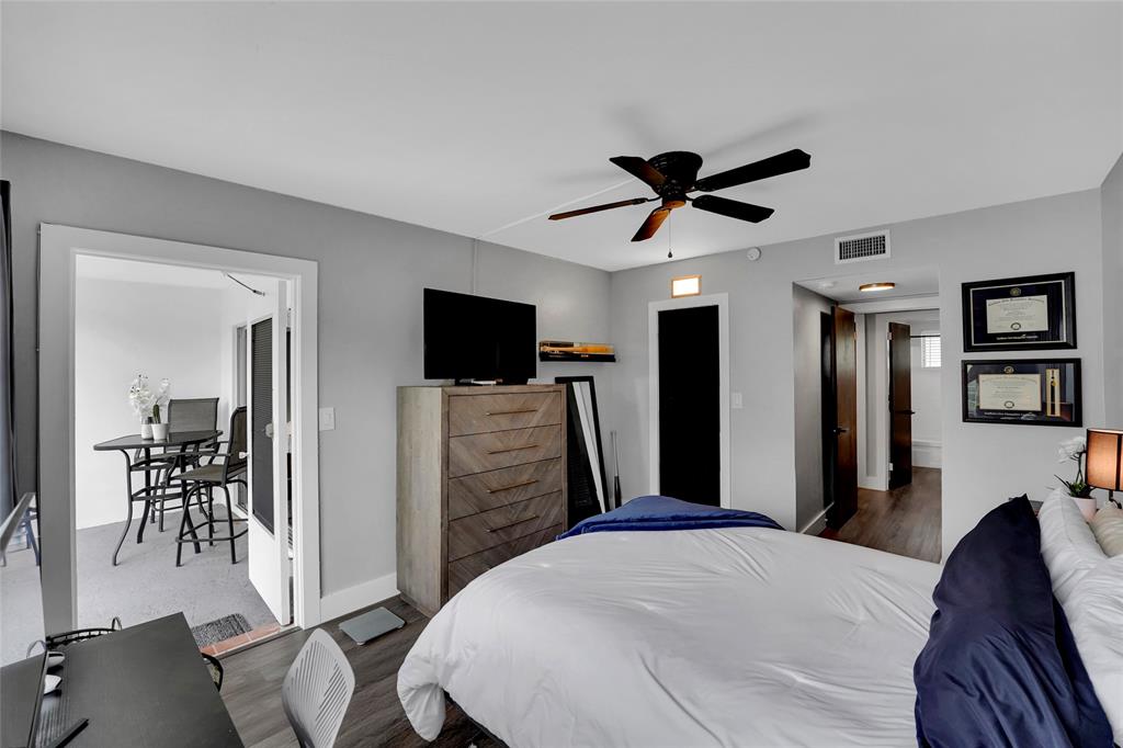 2161 Northeast 42nd Court, Unit 215 Lighthouse Point, FL 33064 - Photo 24 of 50 a bedroom with a bed and a flat screen tv