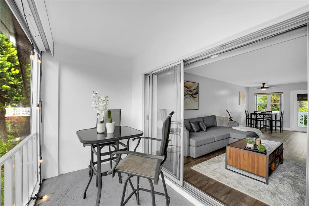 2161 Northeast 42nd Court, Unit 215 Lighthouse Point, FL 33064 - Photo 35 of 50 a living room with furniture and a large window