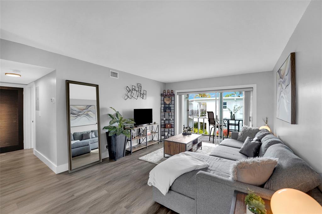 2161 Northeast 42nd Court, Unit 215 Lighthouse Point, FL 33064 - Photo 39 of 50 a bedroom with furniture and a flat screen tv